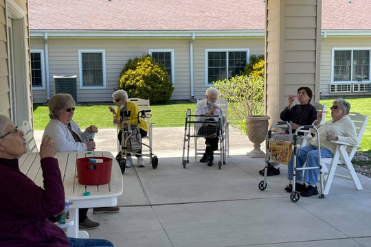 elderly sitting outside on the porch